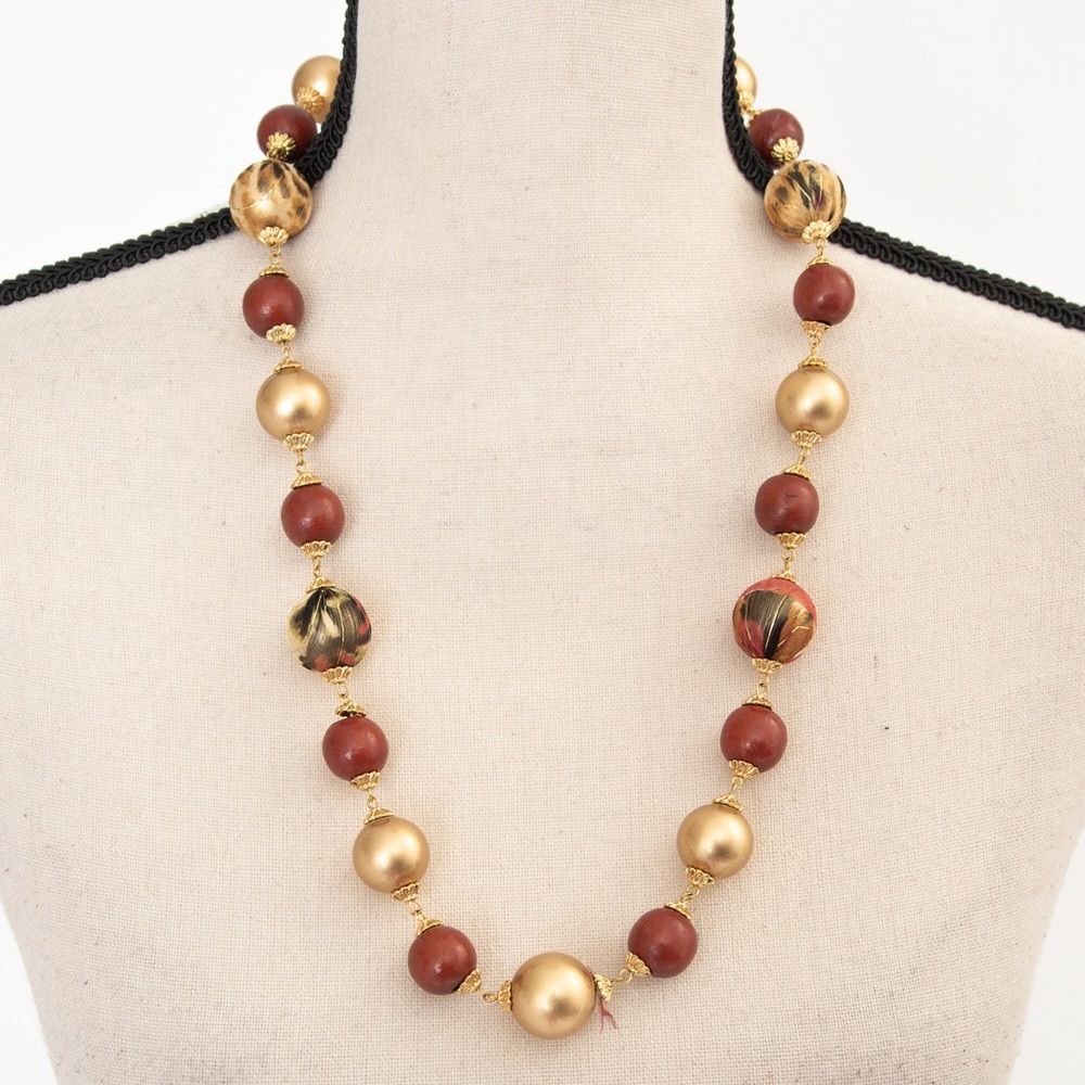 Longer length beaded necklace rust and gold beads and feathered look